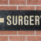 Signpost showing the direction of the nearest GP Surgery