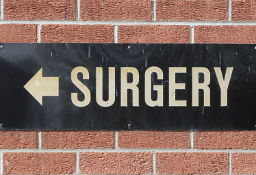 Signpost showing the direction of the nearest GP Surgery